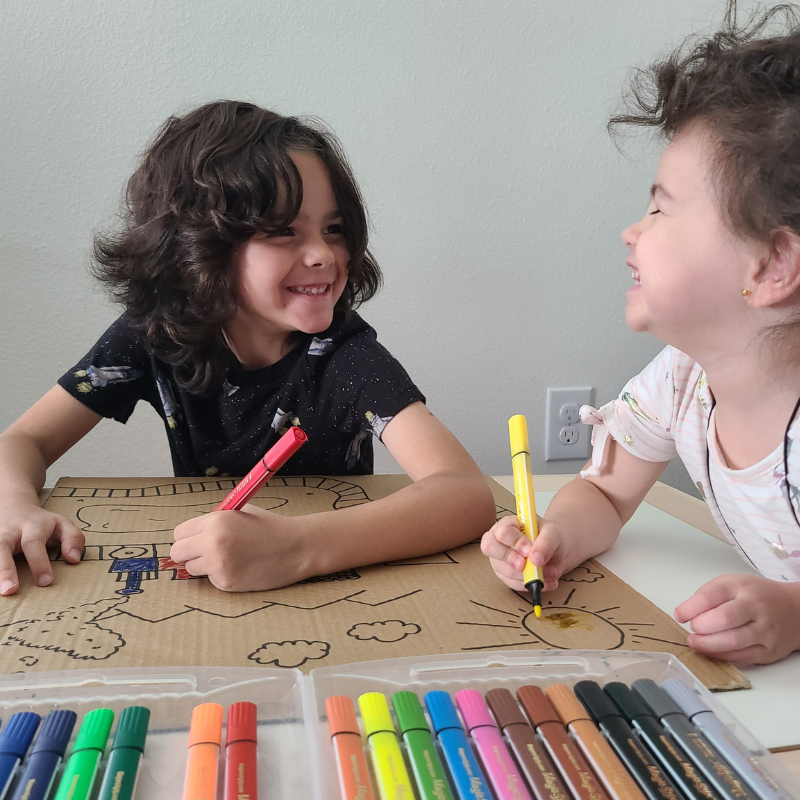 children drawing and laughing with magic stix