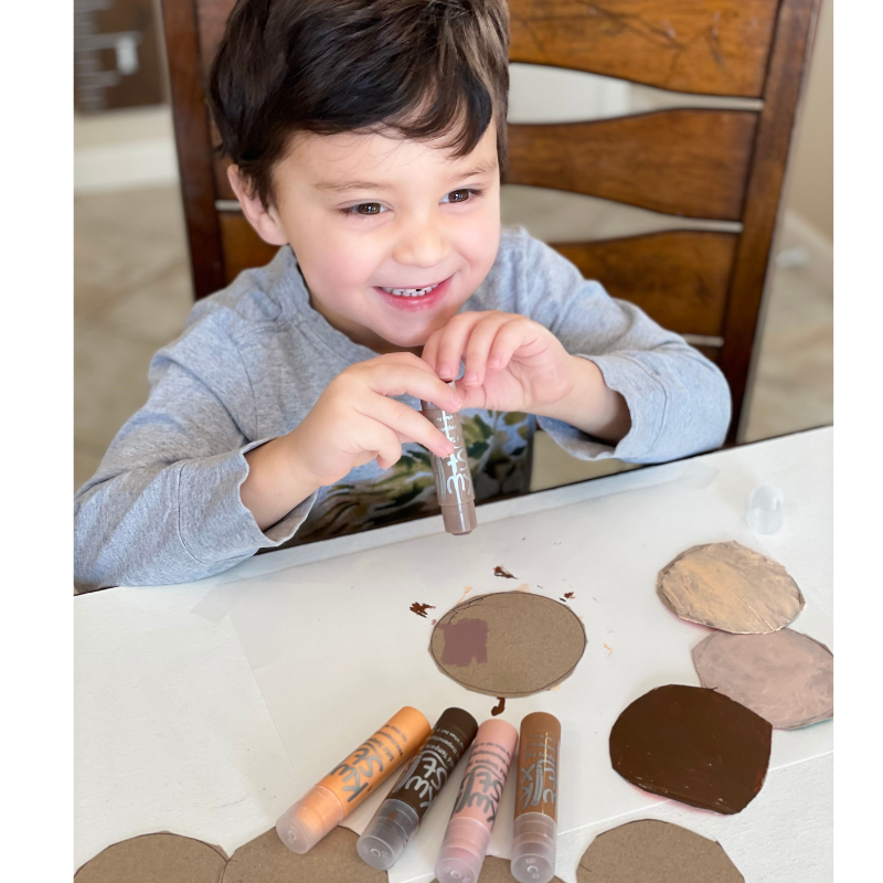boy drawing with global skin tones
